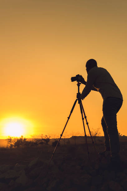 istock Photographer taking photos at sunset 1178730415