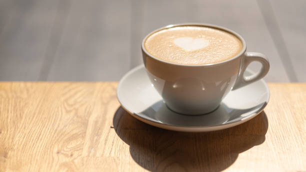 istock a cup of coffee stands on a wooden table. 1178731092
