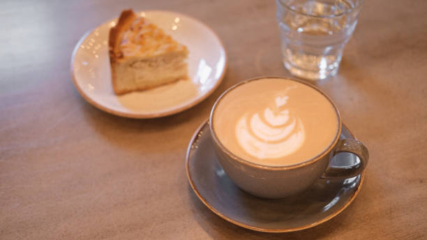istock cup of cappuccino with a piece of cake 1178731111