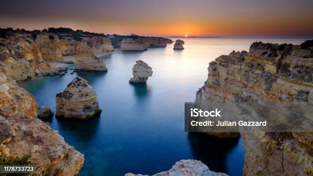 Sunrise Over Faro And The Algarve From Near Plaia Da Marinha Portugal Stock Photo - Download Image Now
