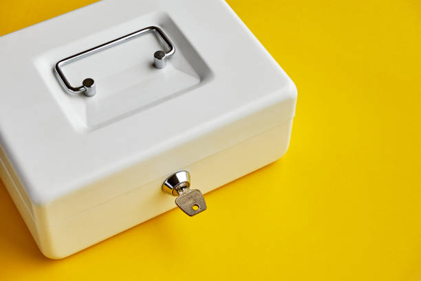 White closed cashbox on yellow background