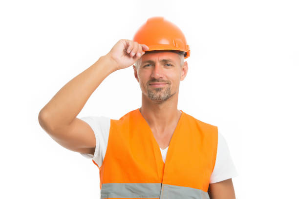 Strong handsome builder. Good job. Safety is main point. Man builder wear protective hard hat and uniform white background. Worker builder confident looking camera. Protective equipment concept.