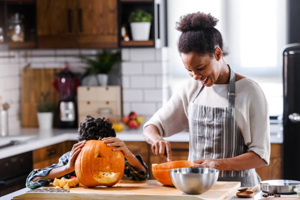 istock Mother and son carving pumpkin making Jack-o-Lantern 1178735023