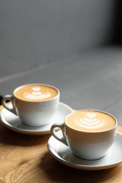 istock two cups of cappuccino are on the table coffee art 1178735200