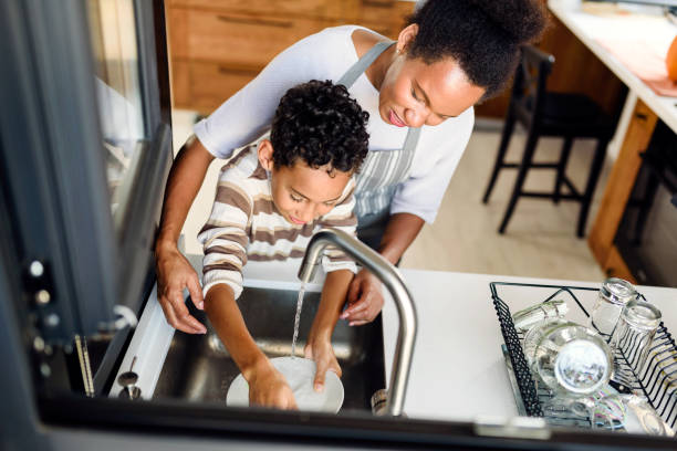 istock Son is helping mother in the Kitchen, Washing Dishes 1178735937