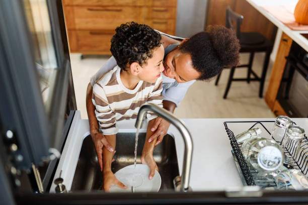 istock Son is helping mother in the Kitchen, Washing Dishes 1178735975