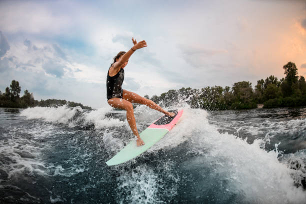 istock Girl wakesurfer jumping with a surf board 1178739991