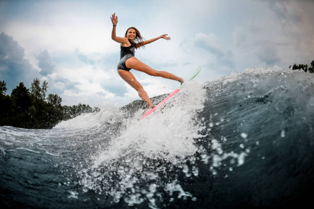istock Girl wakesurfer making stunts on a board 1178740166