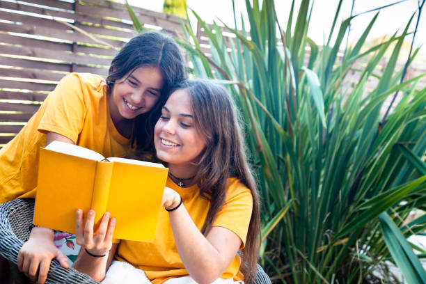 istock Friends reading a book in the garden 1178741913