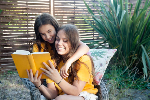 istock Friends reading a book in the garden 1178741915