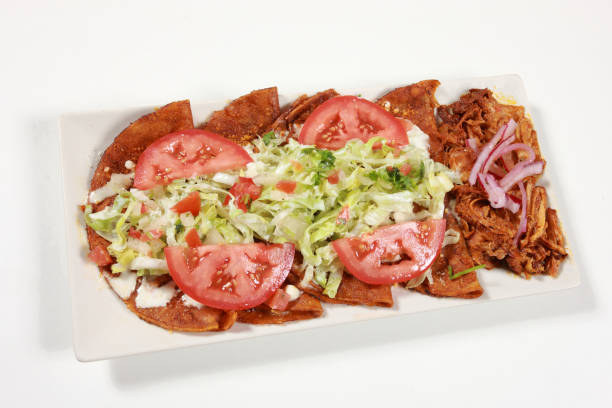 istock Mexican Tortillas stuffed with cheese (Enchiladas Michoacanas) with salad dressing and chicken 1178742773