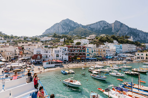 Capri, Italy - September 5, 2019: People on Ferry arriving at Capri Island during a wonderful sunny day, photo taken in the bay of Naples, Italy