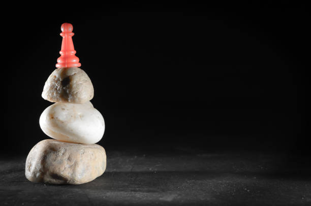 istock Red pawn and stone or black backgrouund 1178747091