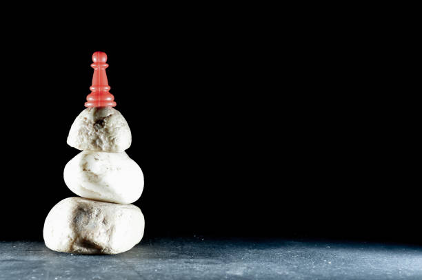 istock Black and white stone on red pawn 1178747163