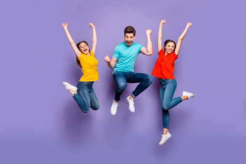 Full length size body photo of three funny funky ecstatic excited delightful buddies having fun on weekend isolated violet background