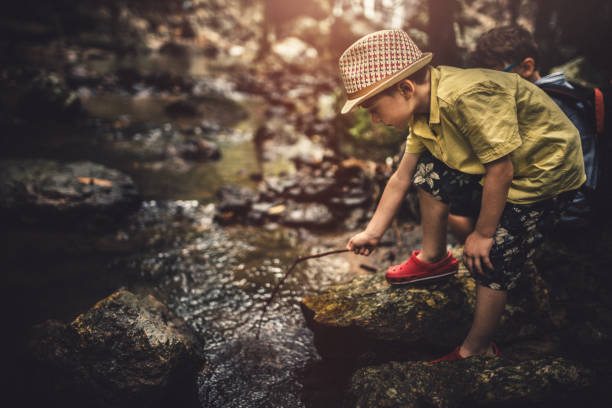 istock Cute boy having fun in the forest near river 1178749121