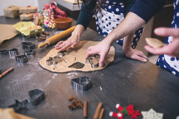 istock Happy couple making Christmas cookie from dough in the kitchen 1178749470