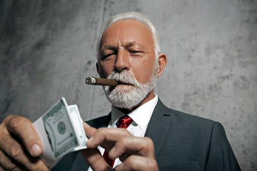 Businessman with cigar and dollar bills