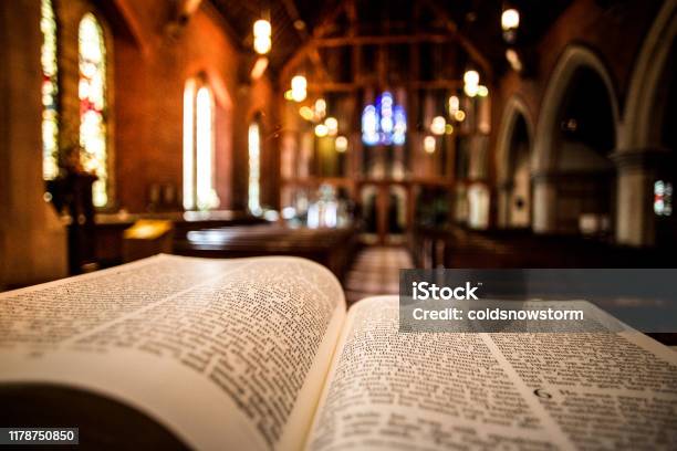 Open Holy Bible On Altar Inside Illuminated Church Stock Photo - Download Image Now - Catholicism, Religious Mass, Church
