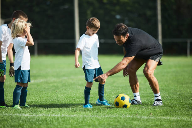 istock Coach is training an 8 year old team on a soccer field. 1178753200