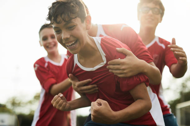 A soccer player celebrates a goal. Lifestyle children training and playing soccer. sport stock pictures, royalty-free photos & images