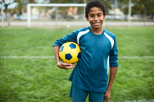 Lifestyle children training and playing soccer.
Teenage soccer player portrait looking at camera.