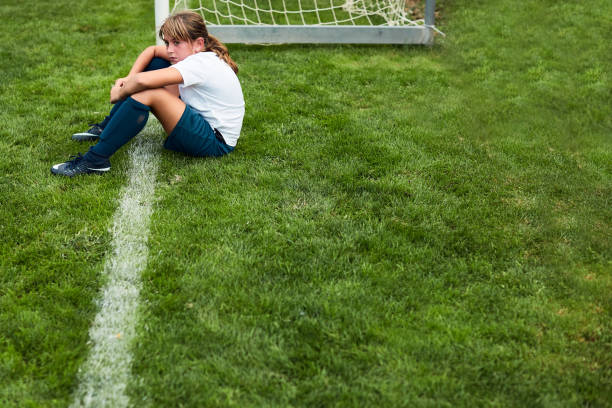 Young girl sitting on the grass after a match defeat. Lifestyle children training and playing soccer.
Young girl sitting on the grass after a match defeat. athlete fails stock pictures, royalty-free photos & images