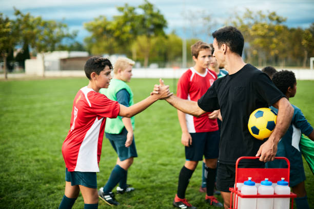 istock The soccer team greets its coach after the training class. 1178753233