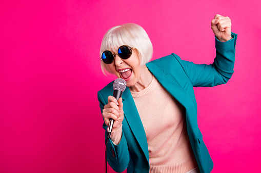 Portrait of her she nice-looking attractive lovely cheerful gray-haired lady, singing cool hit spending weekend isolated on bright vivid shine vibrant pink fuchsia color background