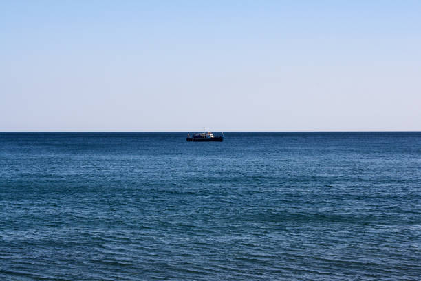 istock alone ship on the sea horizon 1178753762
