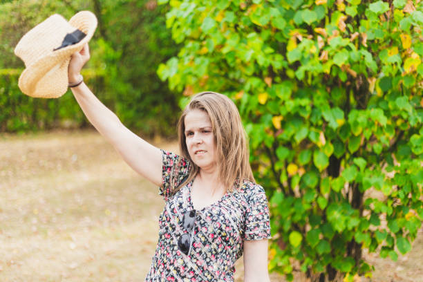 istock Happy woman waving goodbye with summer hat 1178754655