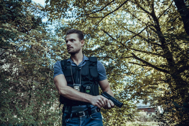 istock Portrait of policeman walking in forest 1178755978