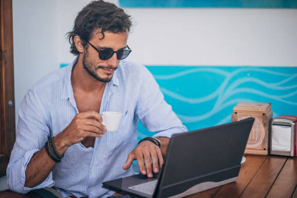 istock Young man with working on laptop at cafe 1178756438
