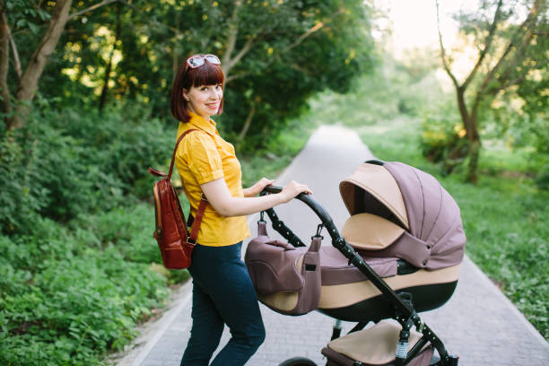 istock walking Mother with baby carriage 1178757077