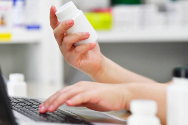 istock Pharmacist using the computer laptop in pharmacy drug store 1178759873