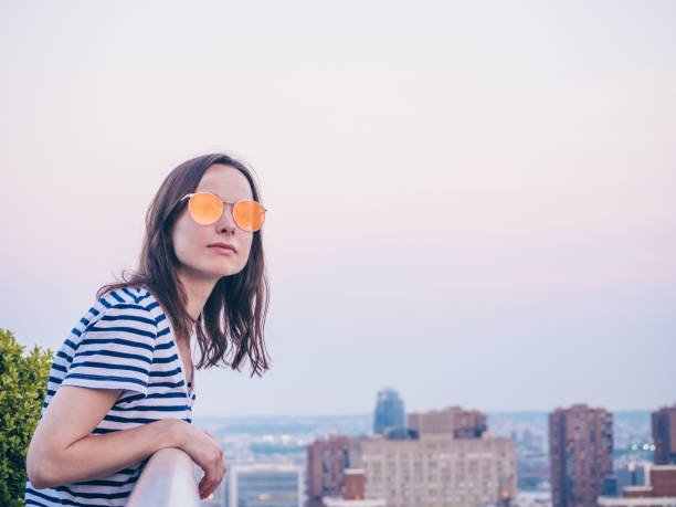 Close up on woman's face with eyewear. Blurred background, lens flare
