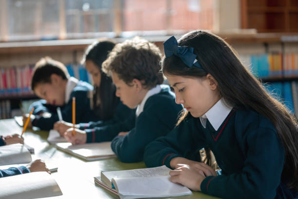 istock Group of students at the school studying at the library 1178762848