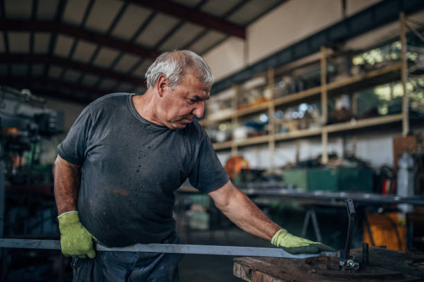 istock Senior man working in metal factory 1178762877