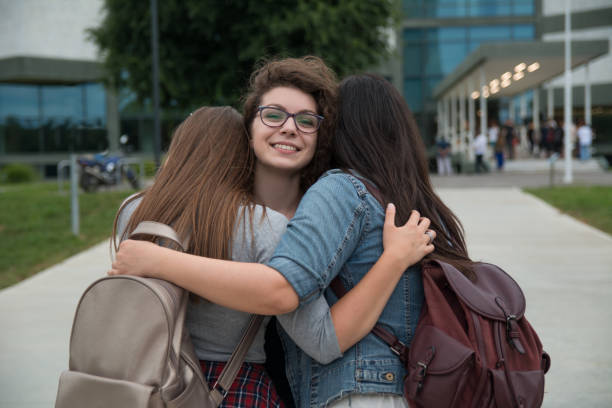 istock Female friends hugging in front of a University campus 1178762878