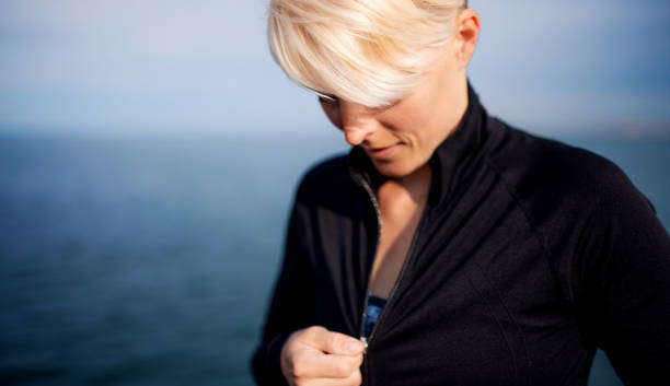 istock Midsection of young sportswoman standing outdoors on beach. 1178763026