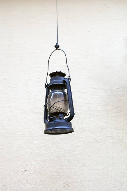 istock Old kerosene lamp hanging on house wall 1178763204
