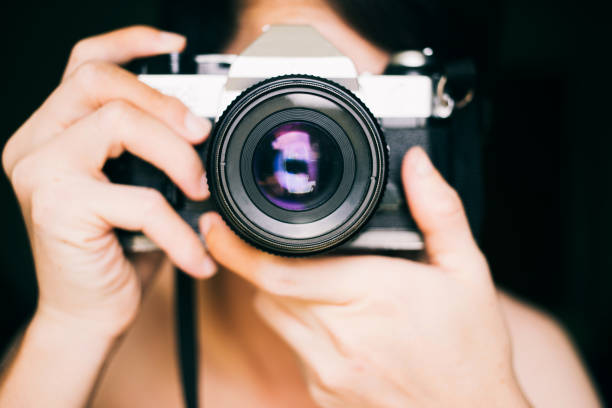 istock Close up man with vintage film camera 1178763377
