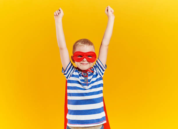 istock Child as superhero with hands raised 1178763403