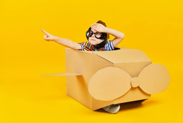 istock Child as astronaut in toy plane pointing at copy space 1178764195