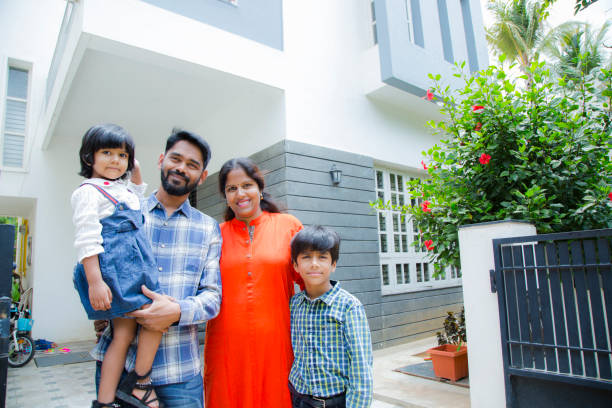 Portrait Of Family Standing Outside Home stock photo Family, Child, Father, Smiling, Mixed Race Person south indian lady stock pictures, royalty-free photos & images