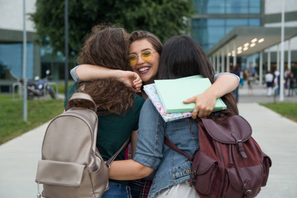 istock Female friends hugging in front of a University campus 1178764382