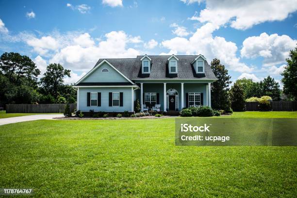 Front View Of Blue House With Siding In The Suburbs Stock Photo - Download Image Now