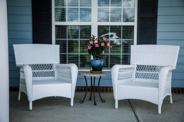 front porch patio with white wicker furniture front porch patio with white wicker furniture including chairs and a small table with a vase and flowers front porch stock pictures, royalty-free photos & images