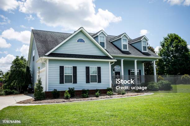Front View Of Blue House With Siding In The Suburbs Stock Photo - Download Image Now