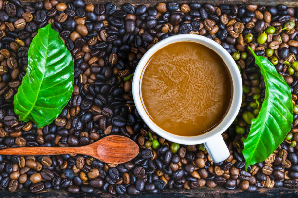 istock A cup of coffee and coffee beans on a wooden table 1178766352